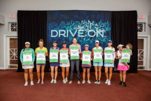 Rachel Rohanna, a 2021 Epson Tour graduate and the first mom to graduate, accepts her LPGA card with daughter Gemelia.